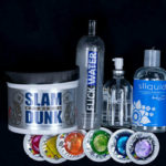 Collection of lubes and condoms on a black background. | QueerDoc